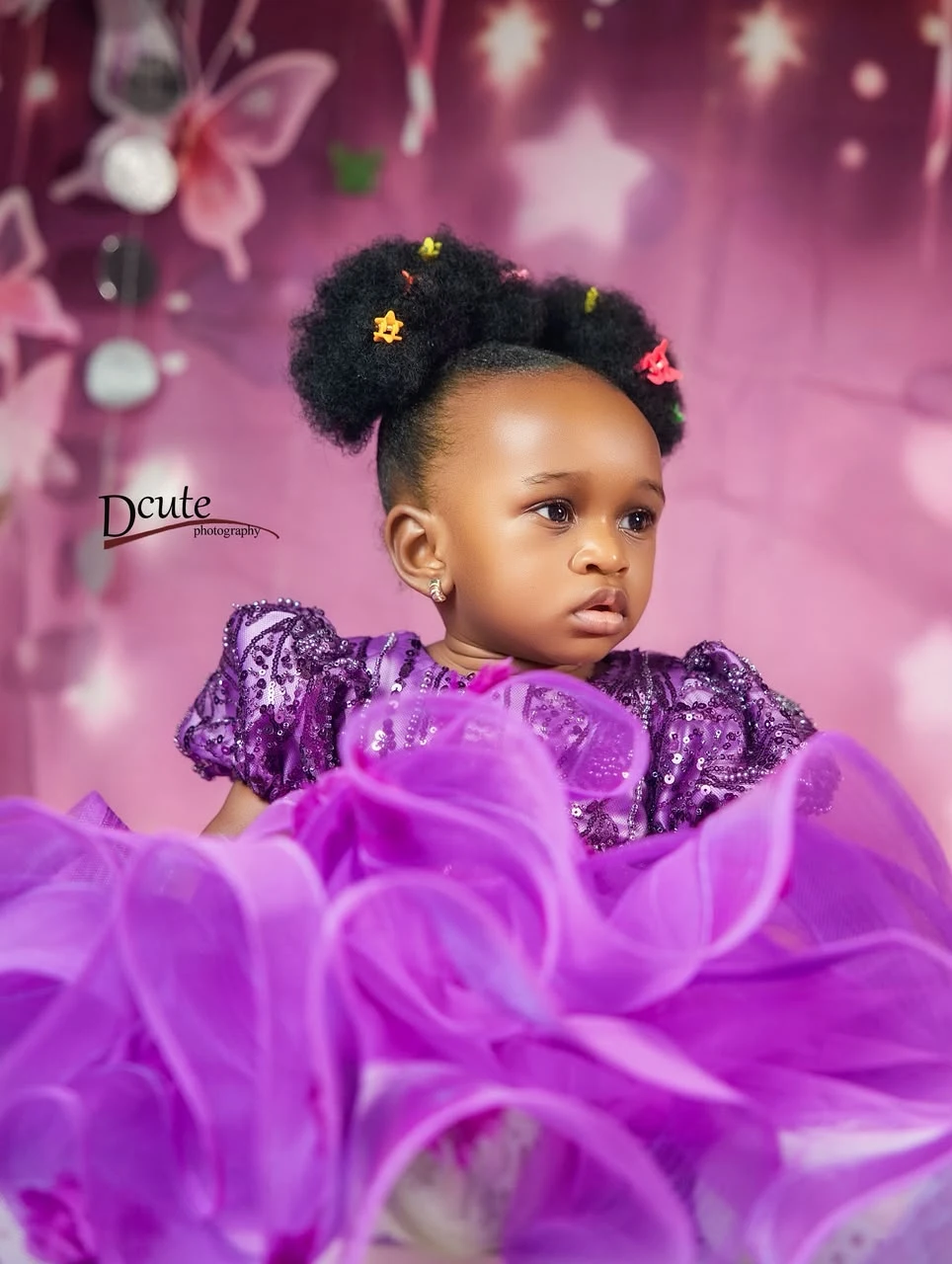 A close-up portrait of Noorah in lilac